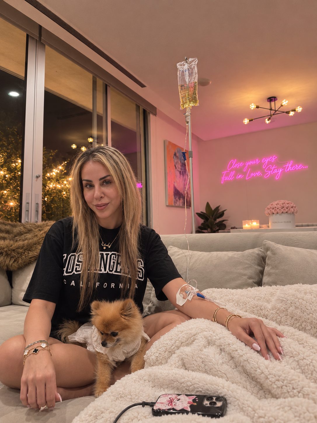 Revive Wellness client relaxing at home in Los Angeles with her dog while receiving a mobile IV drip